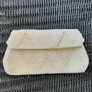 Vintage “Made by Susan” ivory color beaded clutch. Silky interior small pocket.